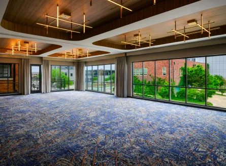 Meeting & Event Space at The Nobleman Hotel in Fort Worth, TX with Modern Lighting, Floor to Ceiling Windows and Adjoining Outdoor Patio.